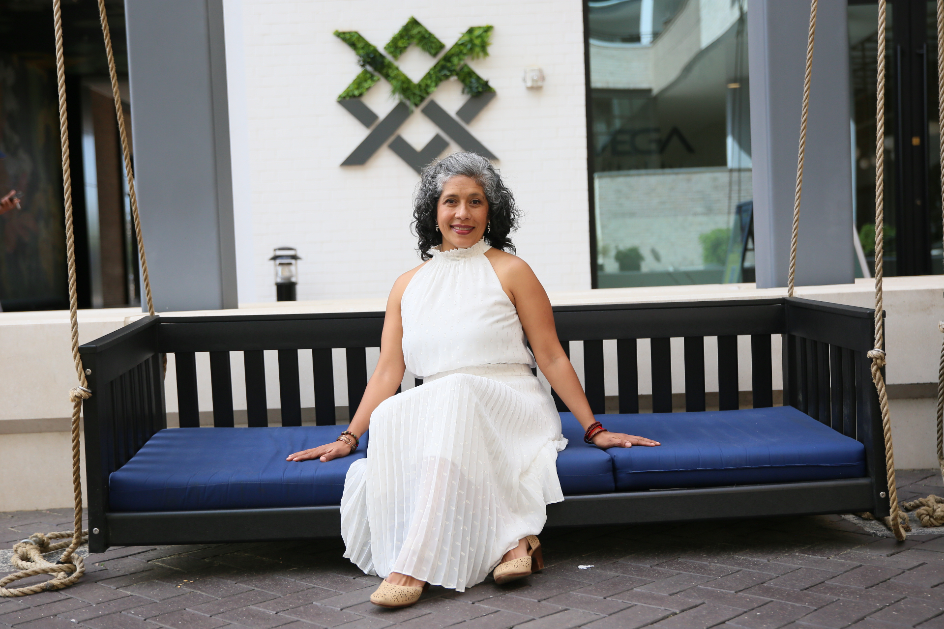 Vania Ramos Ponce seated on a swing bench